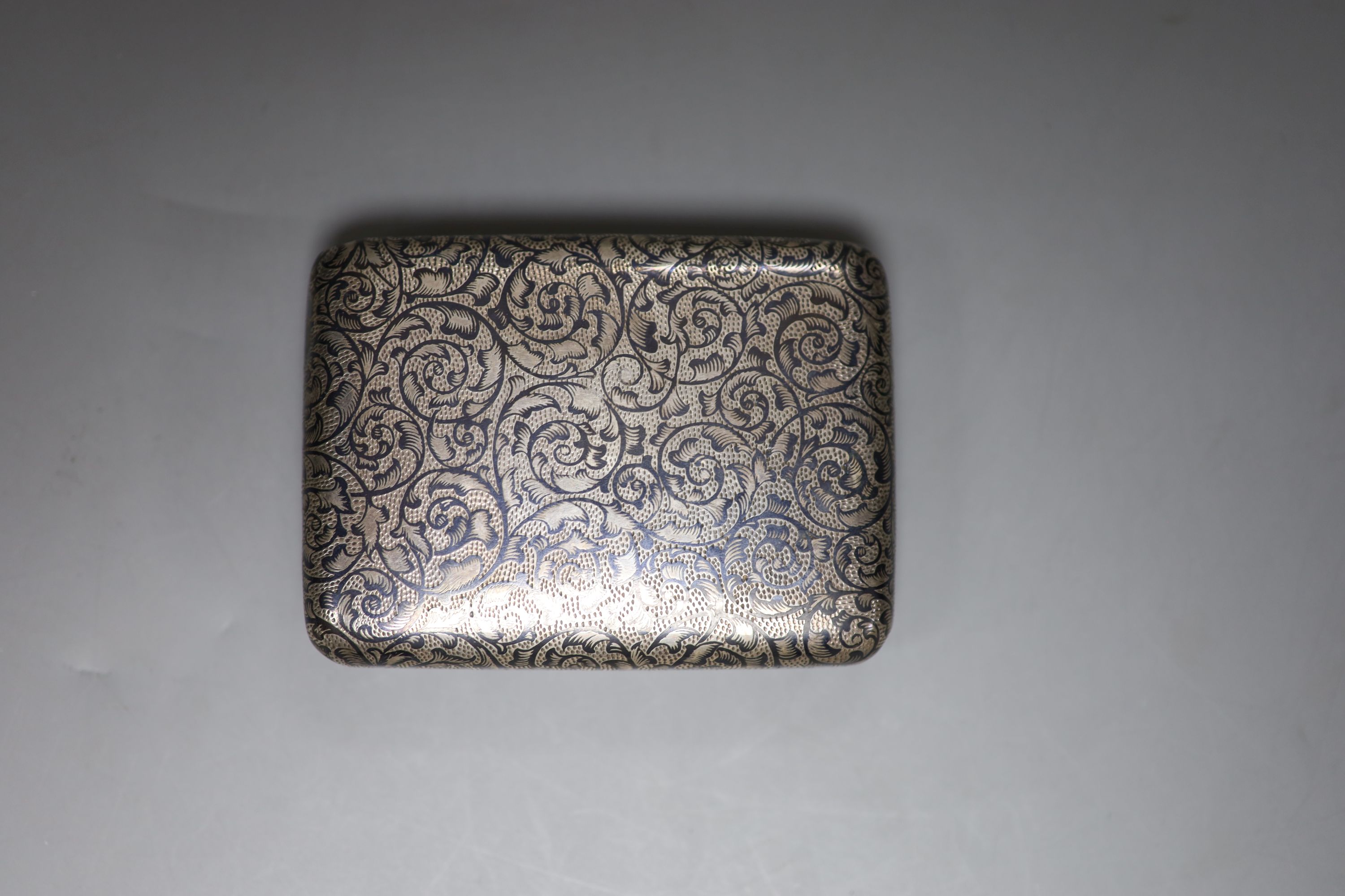 A late 19th century Russian 84 zolotnik and niello cigarette case, 89mm and an Austro-Hungarian 900 standard white metal and niello cigarette case, gross 7oz.